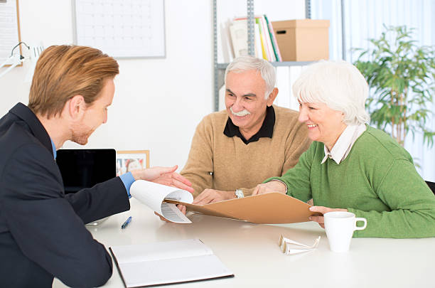 istock Senior couple with consultant. 467370835