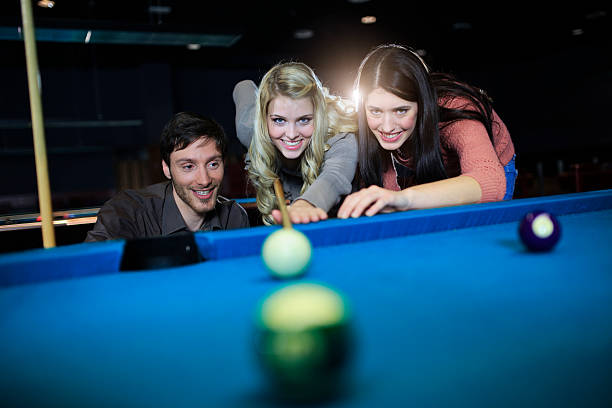 istock friends playing billiard, snooker,pool game 467371689