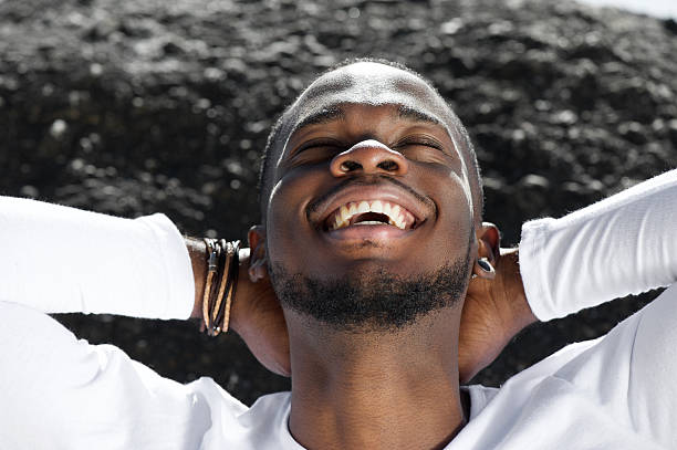istock Cheerful young man laughing outdoors with hands behind head 467372910