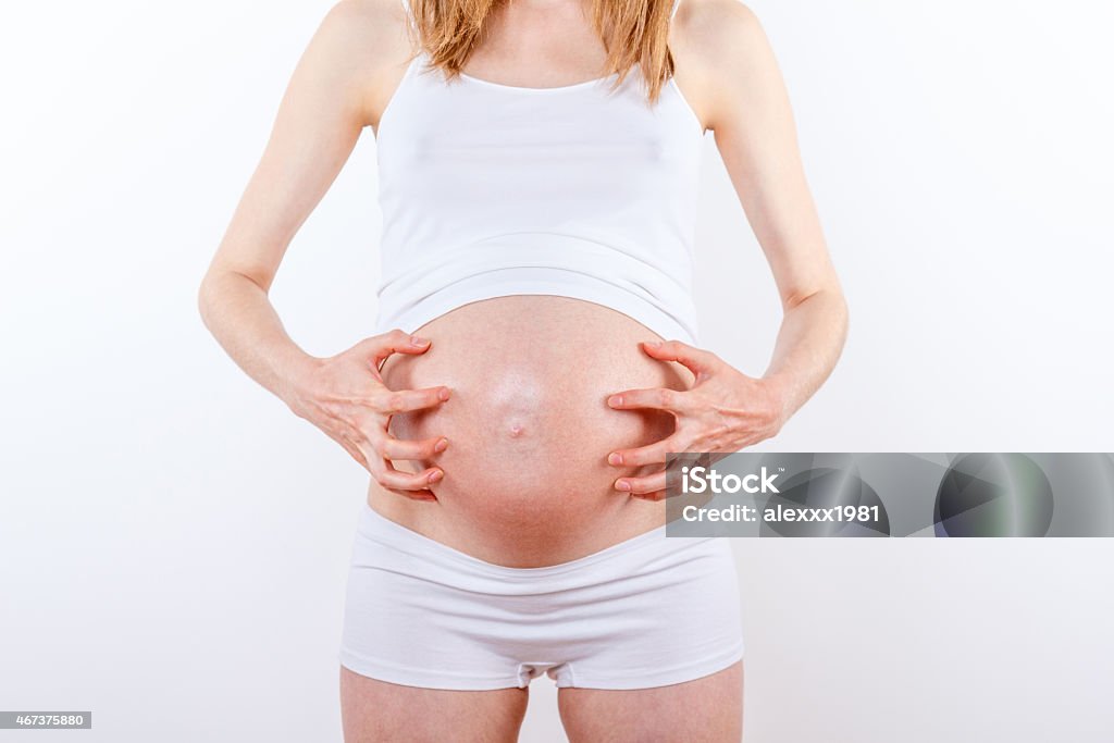 pregnant woman with belly itchings pregnant woman with belly itchings, on white background Human Abdomen Stock Photo