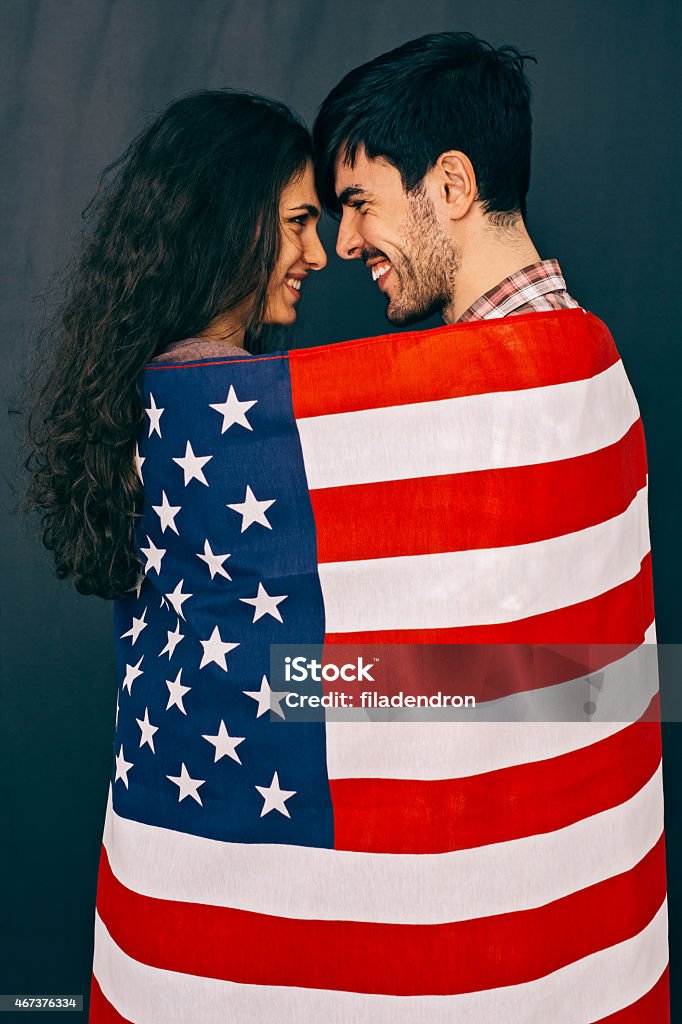 USA Couple wrapped by USA flag 20-29 Years Stock Photo