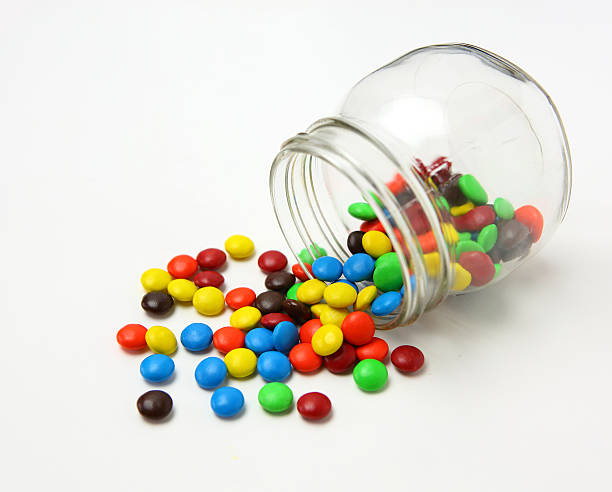 istock Colorful sugar-coated chocolate candies in a glass jar 467379080