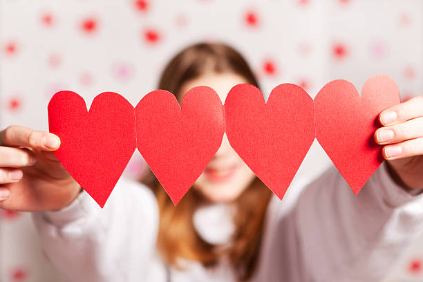 Young Girl Holding Paper Hearts stock photo