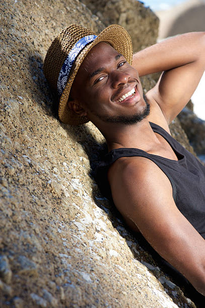 istock Cute african american guy smiling outdoors with hat 467379618