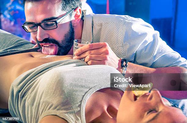 Couple Having Fun In Disco Nightclub With Body Tequila Party Stock Photo - Download Image Now