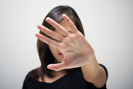 Young woman showing her denial with NO on her hand