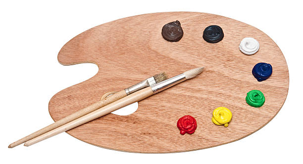 istock wooden art palette with paint and brushes isolated on white 467383771