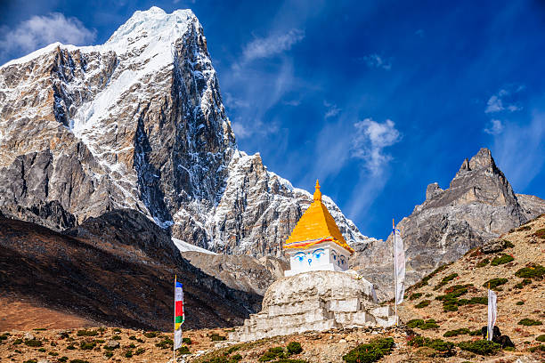 Stupa on the background of Himalayas, Mount Everest National Park, Nepal. This is the highest national park in the world, with the  entire park located above 3,000 m ( 9,700 ft). This park includes three peaks higher than 8,000 m, including Mt  Everest. Therefore, most of the park area is very rugged and steep, with its terrain cut by deep rivers and  glaciers. Unlike other parks in the plain areas, this park can be divided into four climate zones because of the  rising altitude. The climatic zones include a forested lower zone, a zone of alpine scrub, the upper alpine zone  which includes upper limit of vegetation growth, and the Arctic zone where no plants can grow.http://bem.2be.pl/IS/nepal_380.jpg
