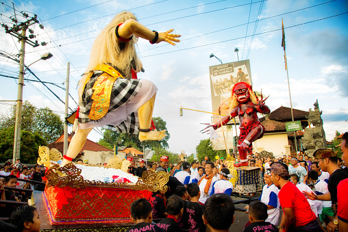 Lovina, Indonesia - March 20, 2015: Battle of the Ogoh-Ogohs during Nyepi Ngrupuk parade in Lovina, North Bali, Indonesia. The two handmade ogress statues, reprensenting all evil things in men are rushed forward by two groups of men and children, simulating a fight at the town square.