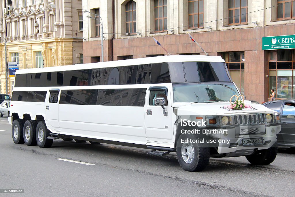 Hummer H2 Moscow, Russia - June 2, 2013: White Hummer H2 wedding limousine drives at the city street. 2015 Stock Photo