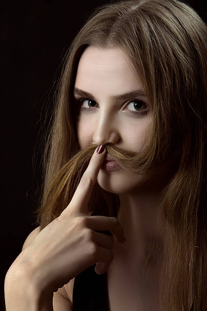 istock woman shows mustache 467388810