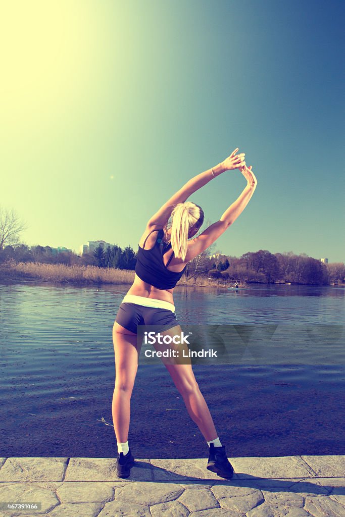 Charging on the street Girl doing exercises on the River 2015 Stock Photo