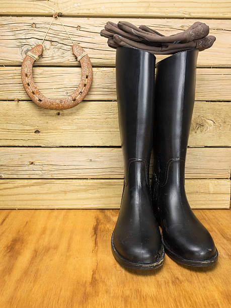 istock riding boots and gloves in a stable 467391500
