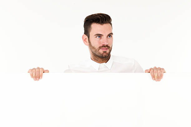 istock Young business man showing blank signboard 467392142