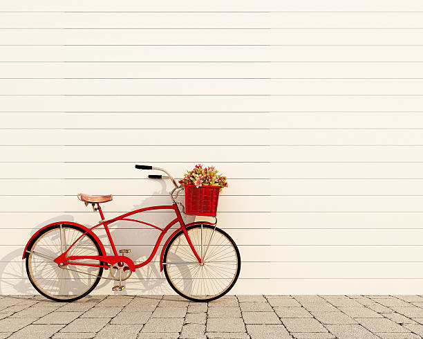 red retro bicycle with basket and flowers