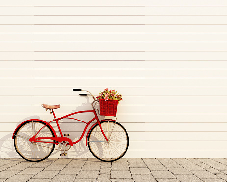 red retro bicycle with basket and flowers