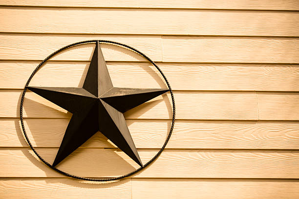 istock Texas star hangs on side of home. Wooden siding.  Copyspace. 467392614