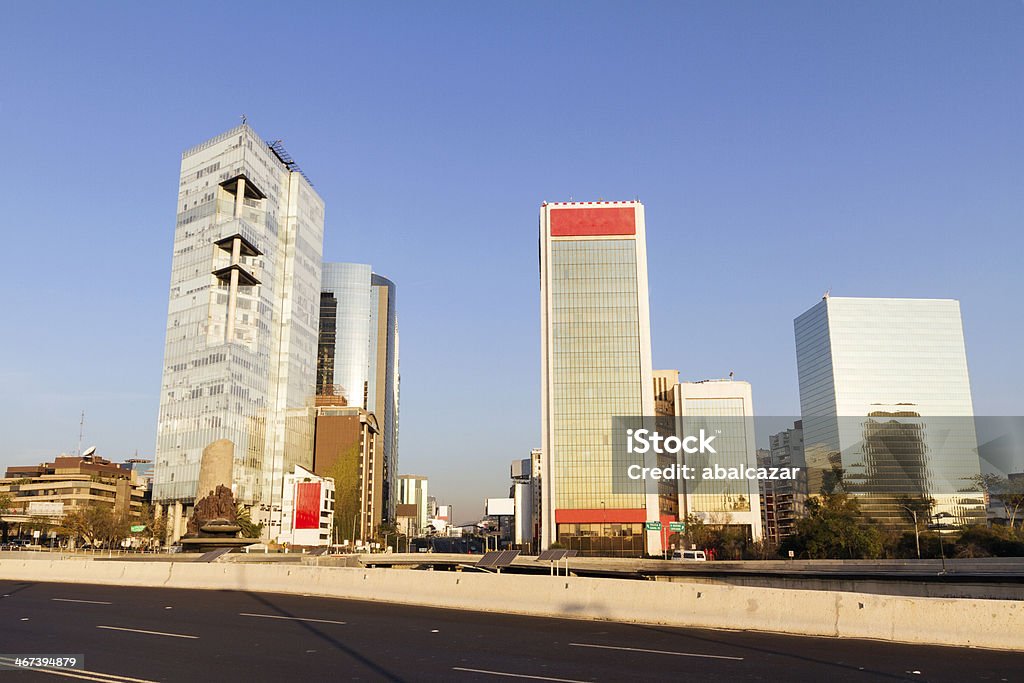 Mexico City skyline The intersection of Paseo de la Reforma and the peripheral ring, recently renovated, featuring the oil nationalization monument and office buildings in the financial district. Shoot at sunrise. Mexico Stock Photo