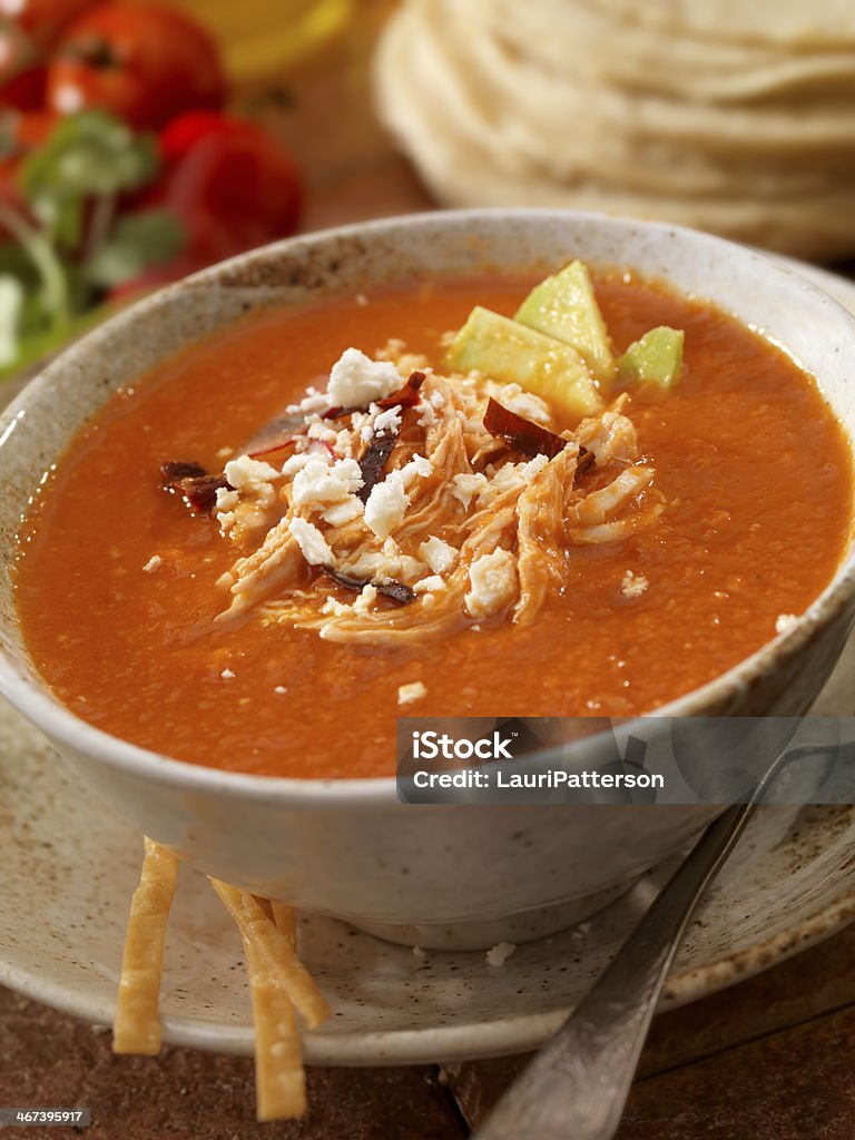 Tortilla soup Authentic Mexican Tortilla Soup - Crispy tortilla stripes smothered in a chipotle tomato broth, garnished with chile pasilla, avocado slices, queso fresco (fresh cheese), sour cream, shredded chicken and radish slices. - Photographed on Hasselblad H3D2-39mb Camera Chicken Meat Stock Photo