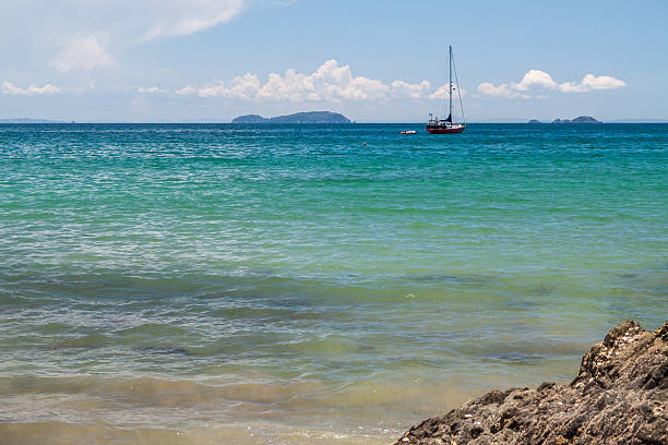 istock Solitary yacht moored off a turquoise blue, sandy beach 467396062