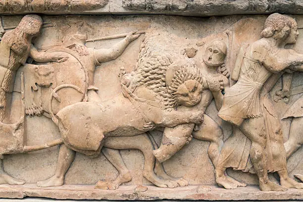 Marble frieze found in the city of Delphi depicting the fight between Giants and lions along with Troy warriors. It's a very old archeological sculptural frieze depicting Greek Mythology