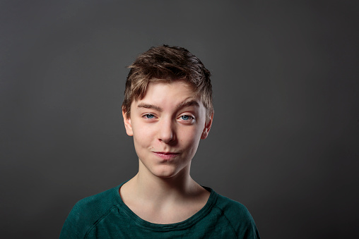 portrait of a smiling teenage boy and gray background for fast isolating