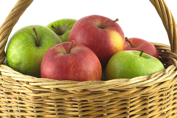 istock Ripe color apples in brown wicker basket isolated 467401073