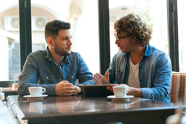 istock Two men in a casual meeting in a Cafe with their coffee 467403192