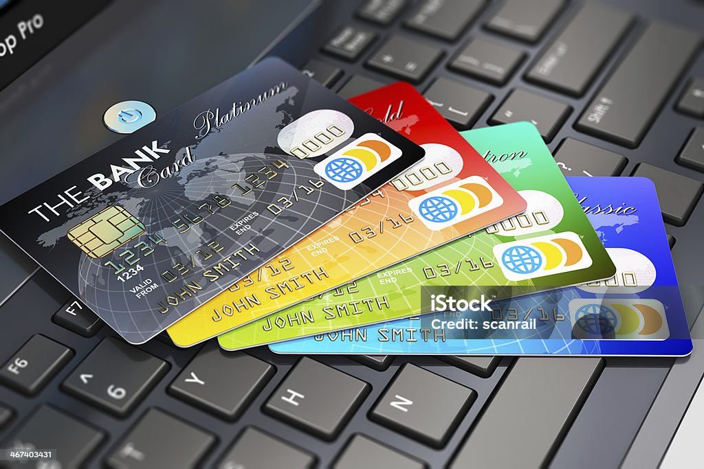 Multiple credit cards lying on a laptop keyboard file_thumbview_approve.php?size=1&id=60162272 Banking Stock Photo