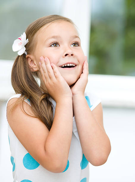 istock Little girl is holding her face 467404979