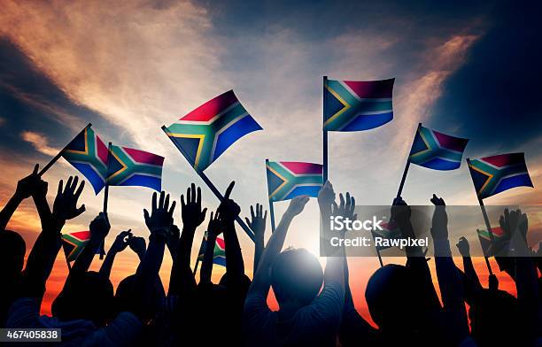 Group Of People Waving South African Flags In Back Lit Stock Photo - Download Image Now