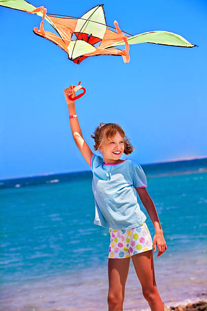istock Kid flying kite outdoor 467408402
