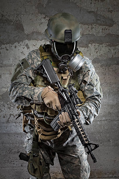 istock Gas mask soldier with rifle 467409605