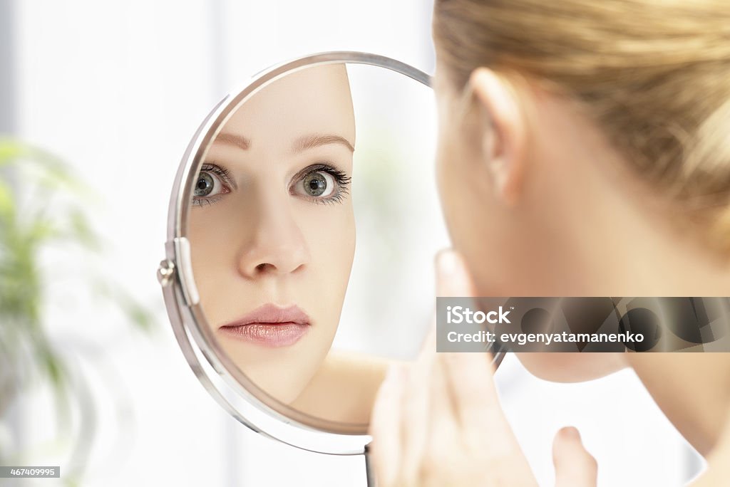 young beautiful healthy woman and reflection in the mirror face of young beautiful healthy woman and reflection in the mirror Mirror - Object Stock Photo