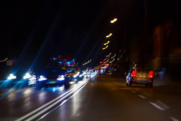 istock car lights on highway by night,abstract light trace background 467411124