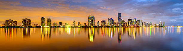 istock Panoramic of Miami buildings at night reflected on water 467411276