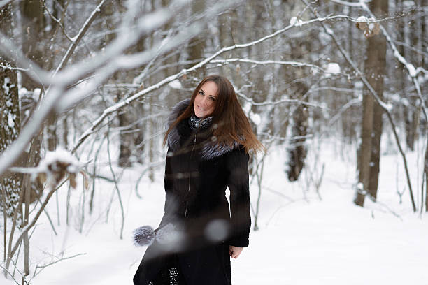istock woman in winter forest 467411308