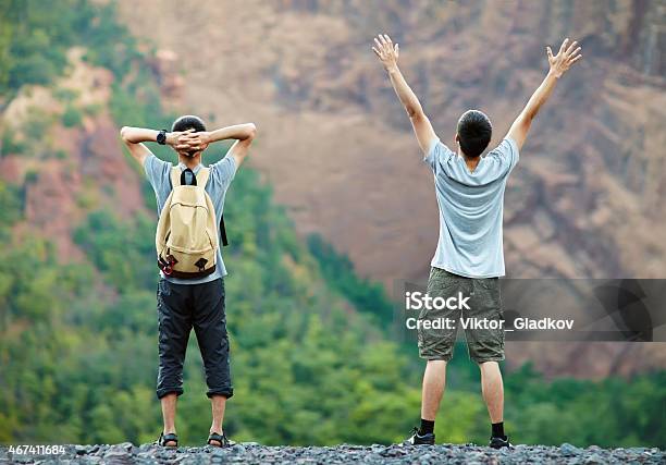 Two Happy Men Enjoying Nature Stock Photo - Download Image Now - Hand Raised, Rear View, 2015