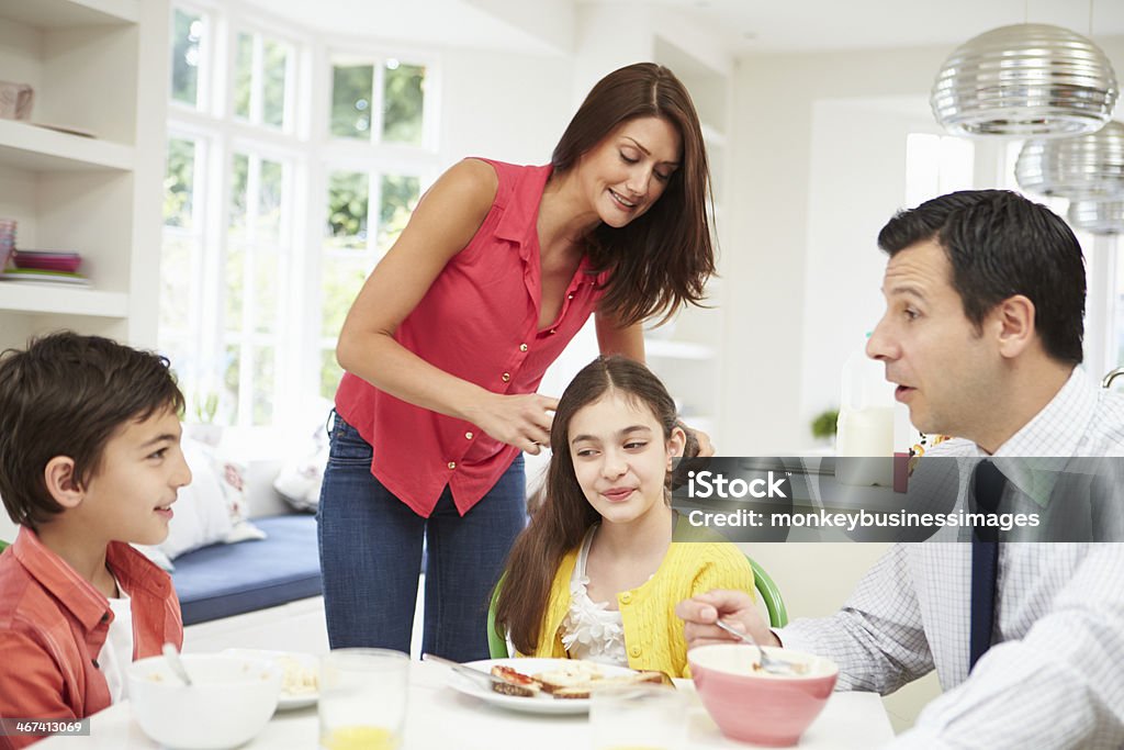 Family Having Breakfast Before Husband Goes To Work Family Having Breakfast Before Husband Goes To Work And Children To School 10-11 Years Stock Photo