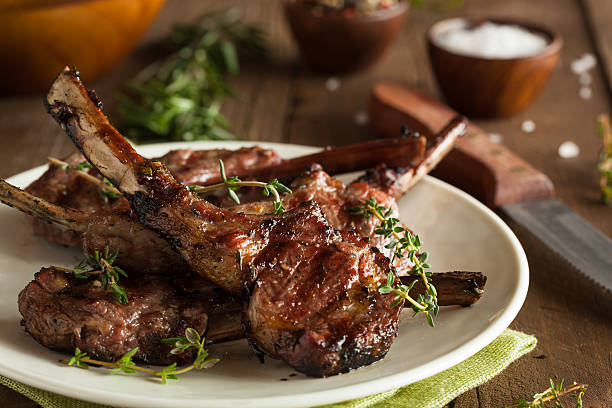 Grilled lamb chops organized on a white plate on wood Organic Grilled Lamb Chops with Garlic and Lime lamb meat photos stock pictures, royalty-free photos & images