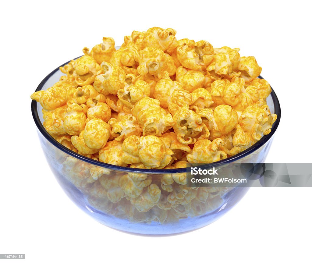 Cheese popcorn in bowl A blue bowl filled with cheese flavored popcorn on a white background. Blue Stock Photo