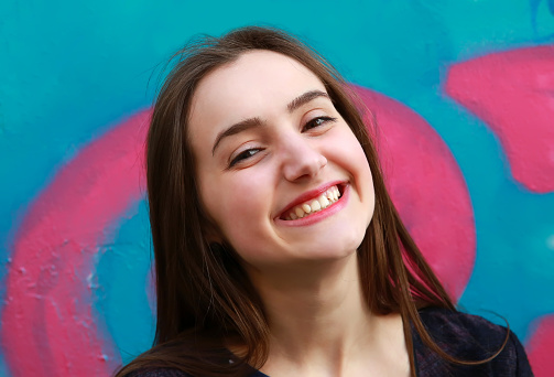 Close-up portrait of beautiful girl on colorful background