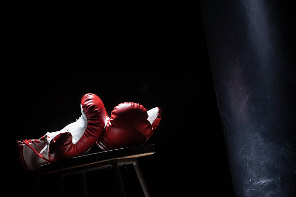 istock Boxing gloves on round table with punching bag 467425978