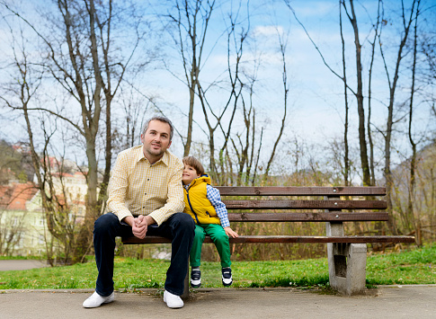 father and little boy spending time in park.