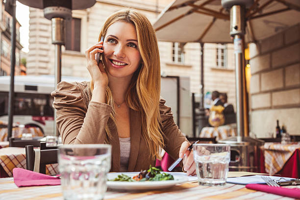 moda donna parlare al telefono presso il ristorante - white telephone filing documents one person foto e immagini stock