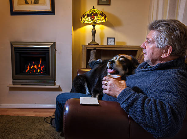 istock Mature man and his dog on sofa 467428992