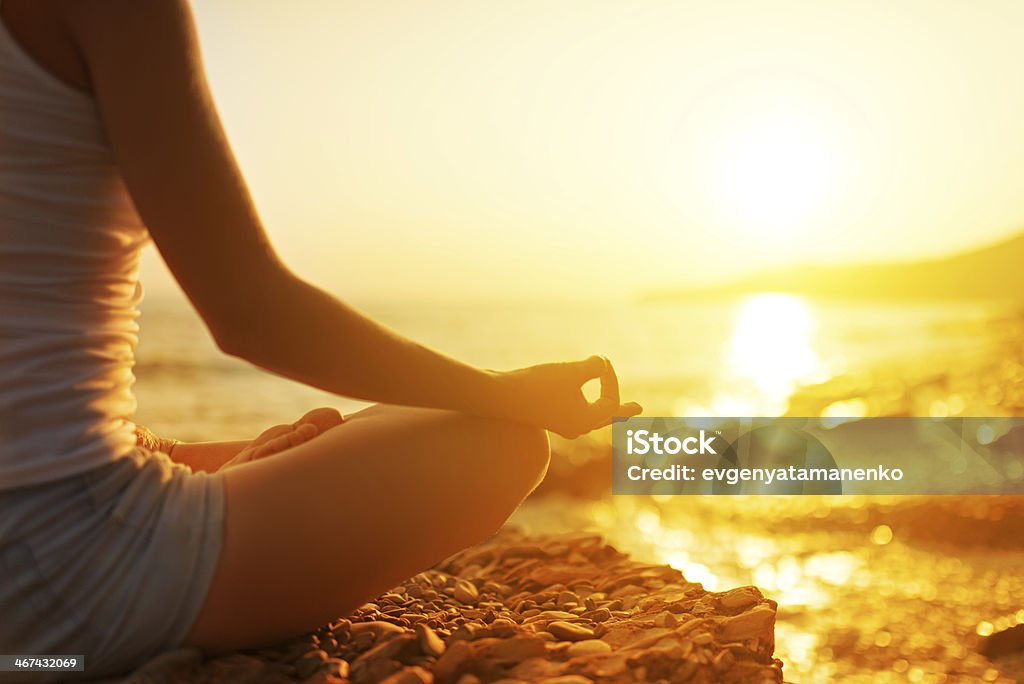 hand of  woman meditating in a yoga pose on beach hand of a woman meditating in a yoga pose on the beach Beach Stock Photo