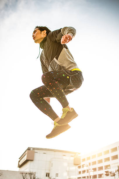istock Japanese man jumping high on the city 467437408
