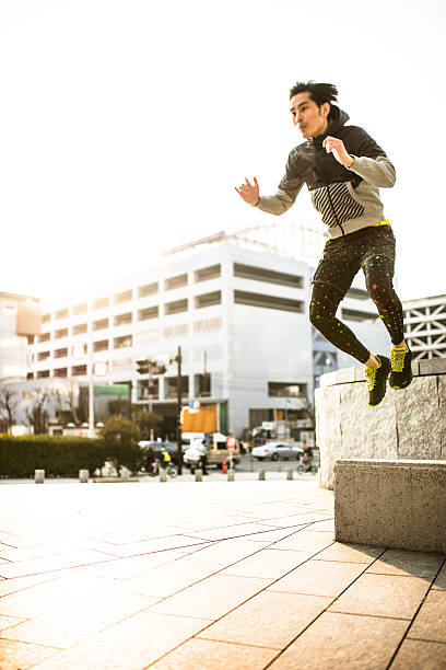 istock Japanese man jumping high on the city 467437416