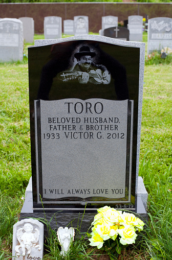 Queens, NY, USA - June 6, 2013: Grave of Yomo Toro, international musician known for the guitar like instrument called a cuatro player.